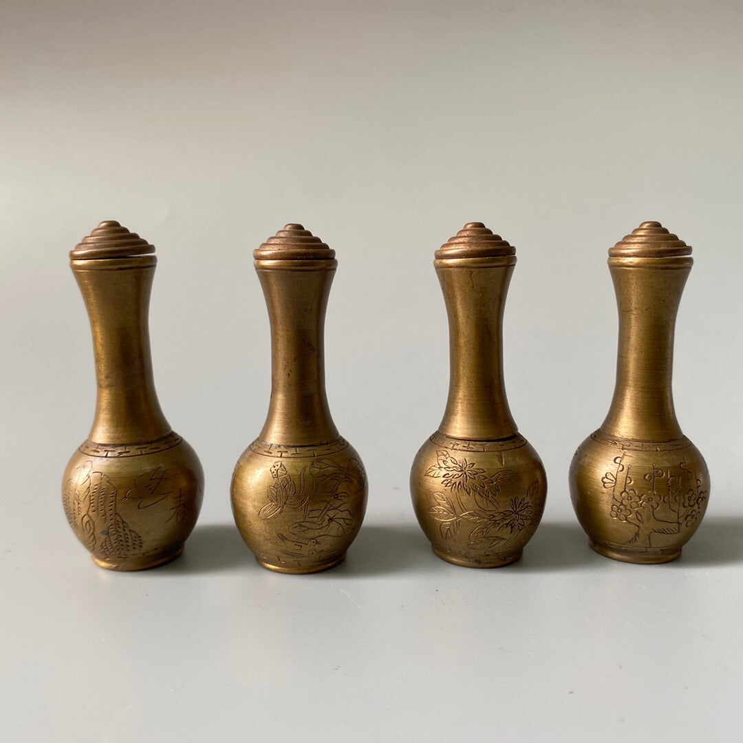A set of carved Chinese antique brass snuff bottles from spring, summer, autumn, and winter