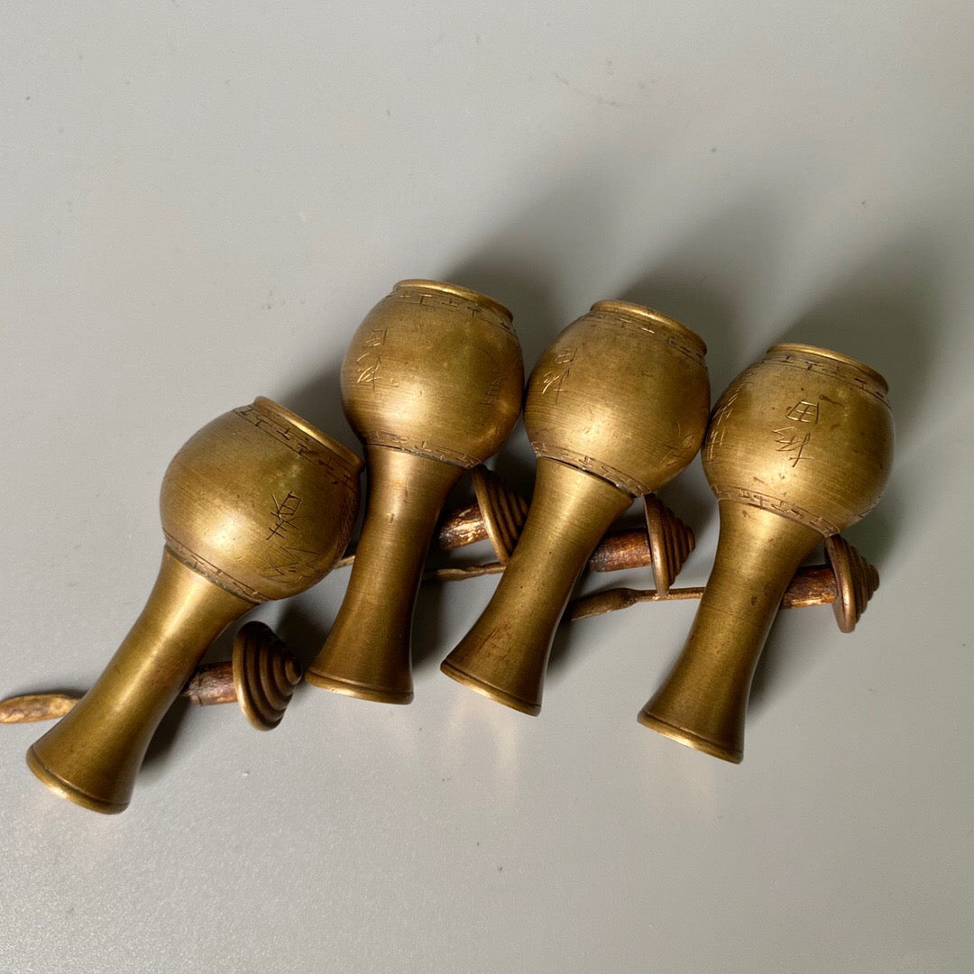 A set of carved Chinese antique brass snuff bottles from spring, summer, autumn, and winter