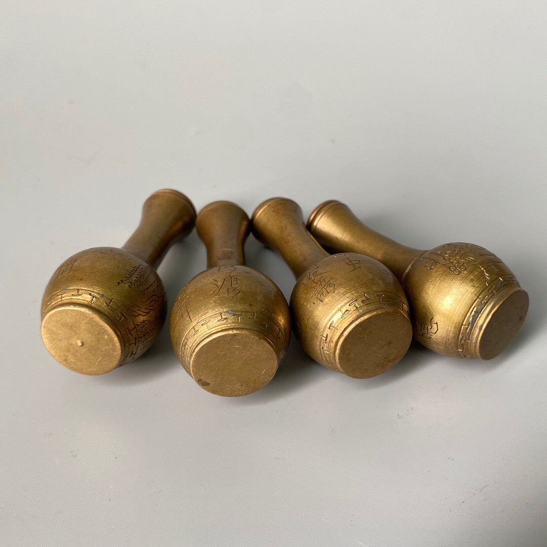A set of carved Chinese antique brass snuff bottles from spring, summer, autumn, and winter