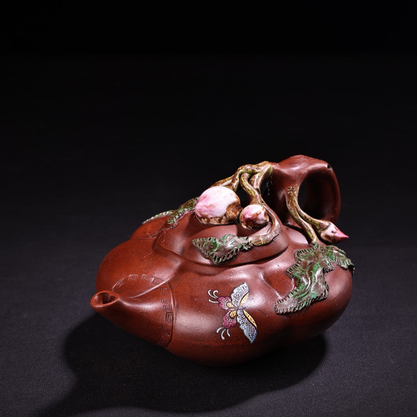 A red clay painted purple clay teapot