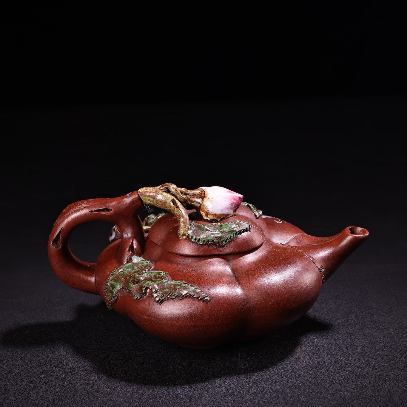 A red clay painted purple clay teapot