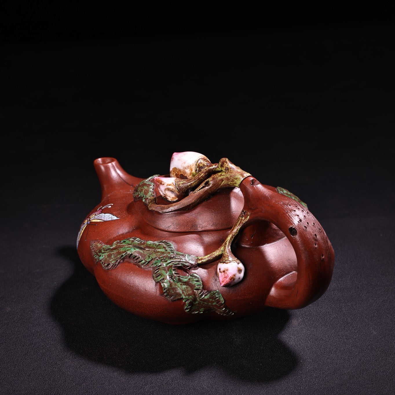 A red clay painted purple clay teapot