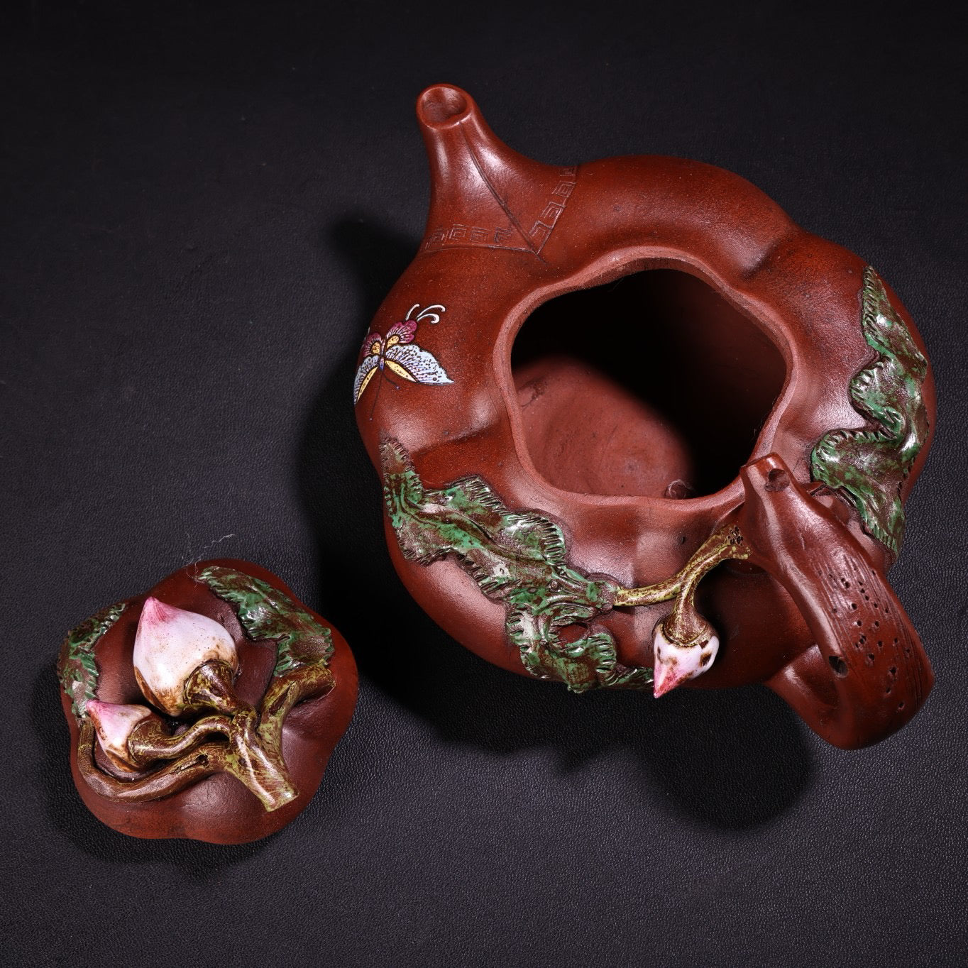 A red clay painted purple clay teapot