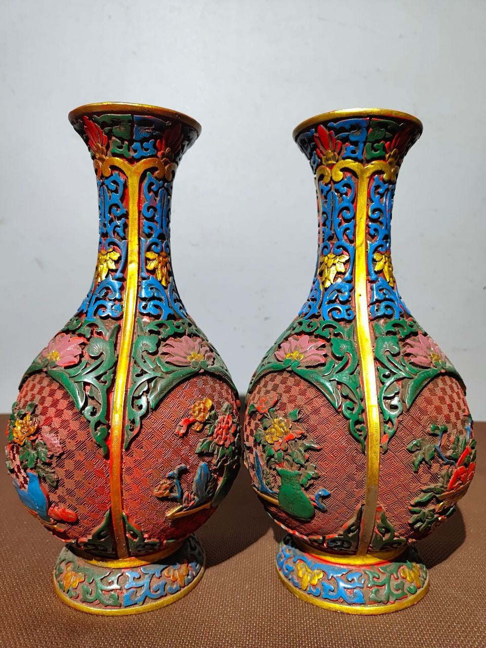 A pair of red lacquerware bottles