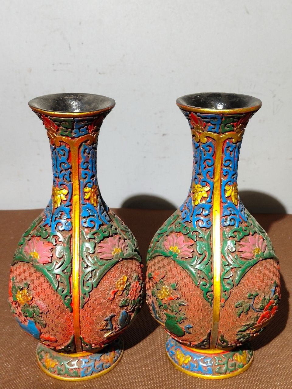 A pair of red lacquerware bottles