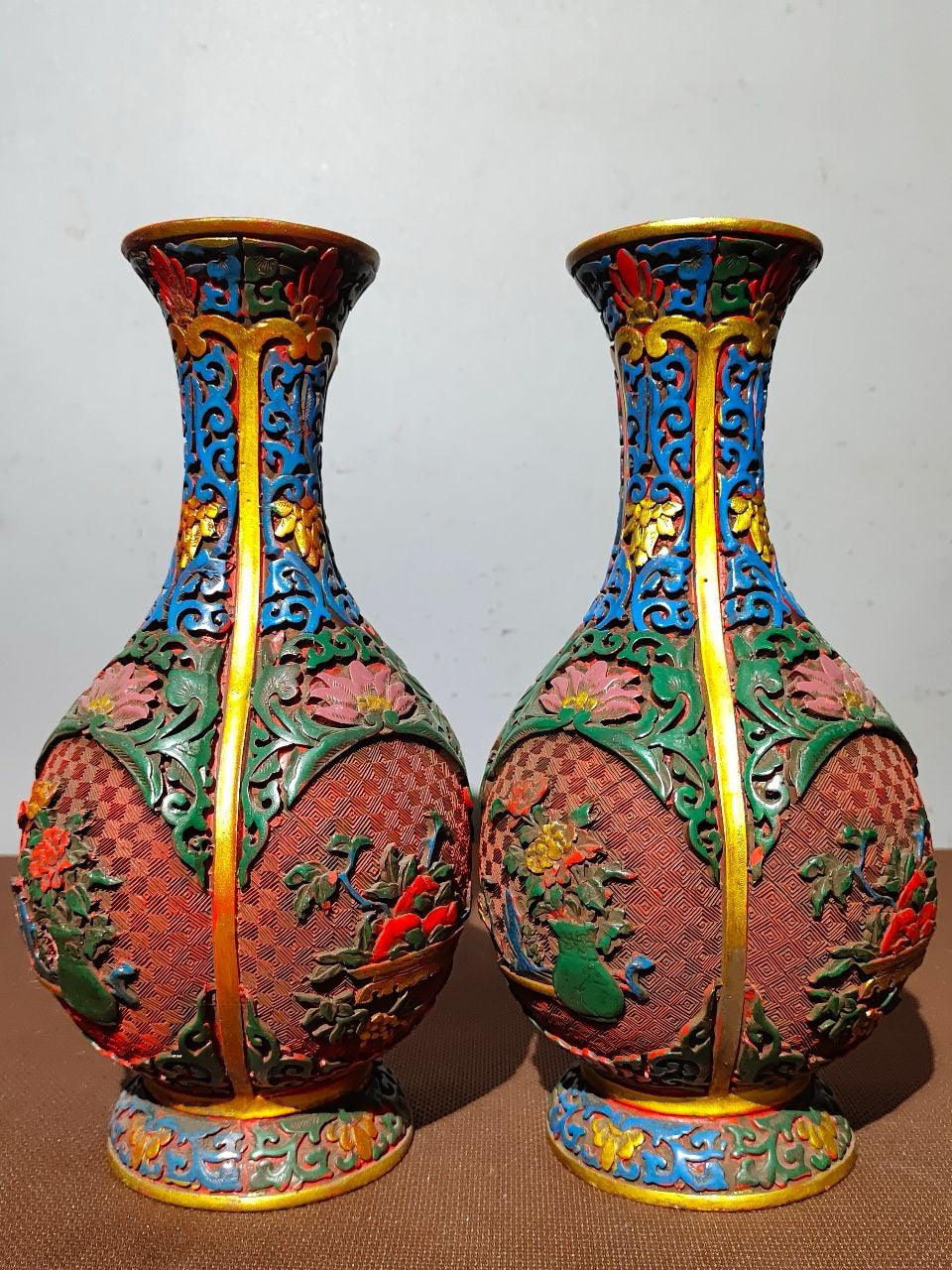 A pair of red lacquerware bottles