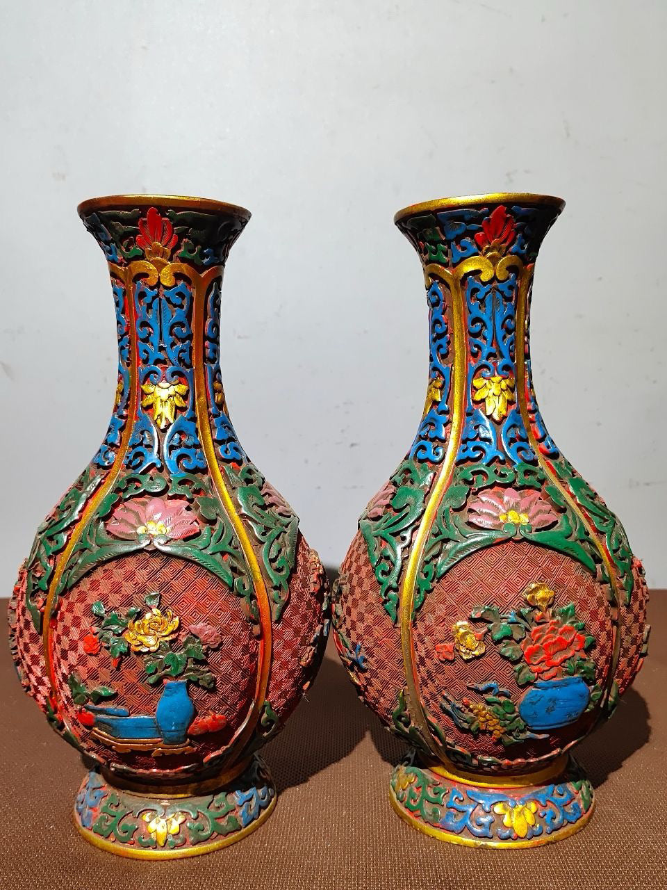 A pair of red lacquerware bottles