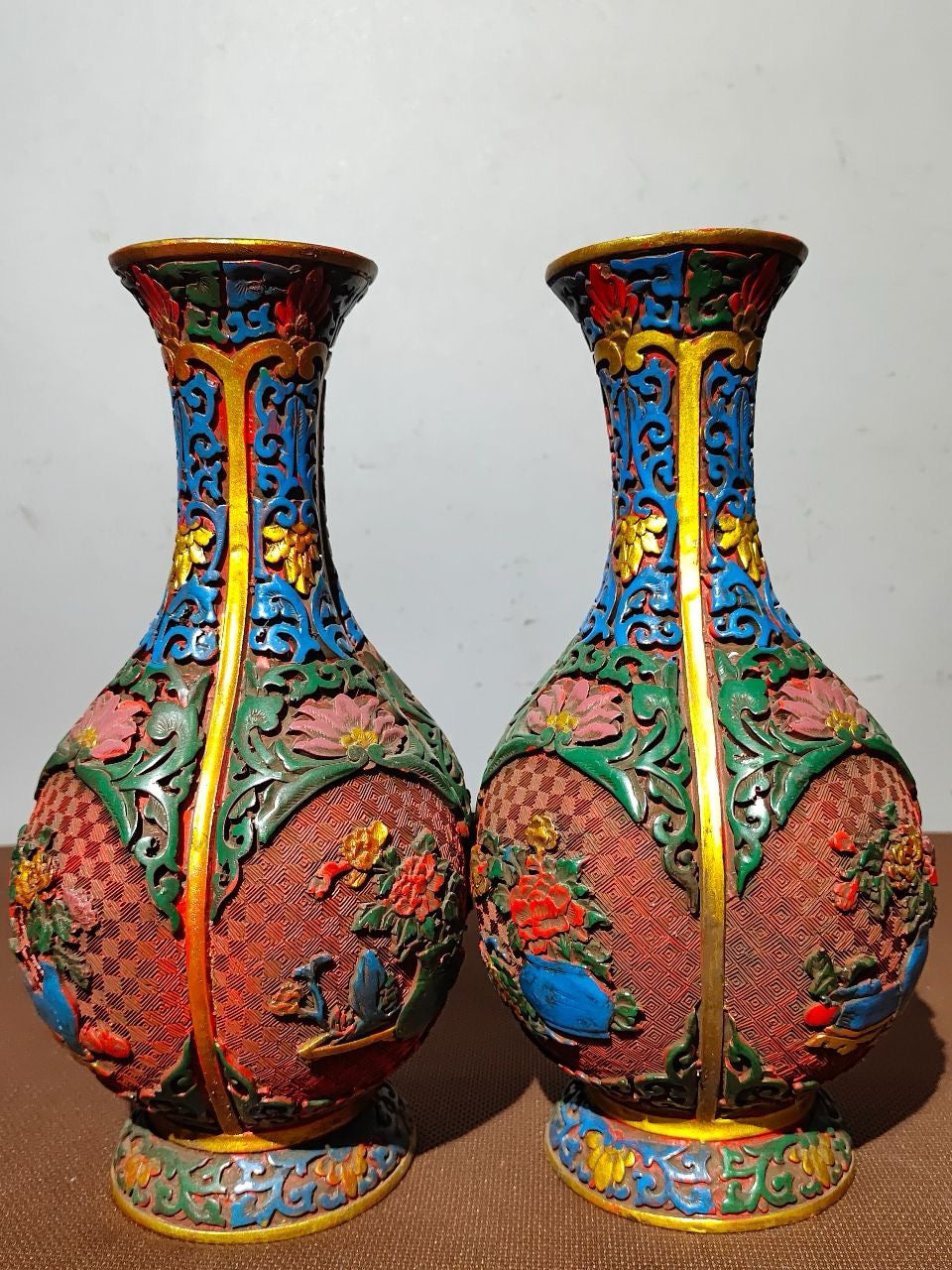 A pair of red lacquerware bottles