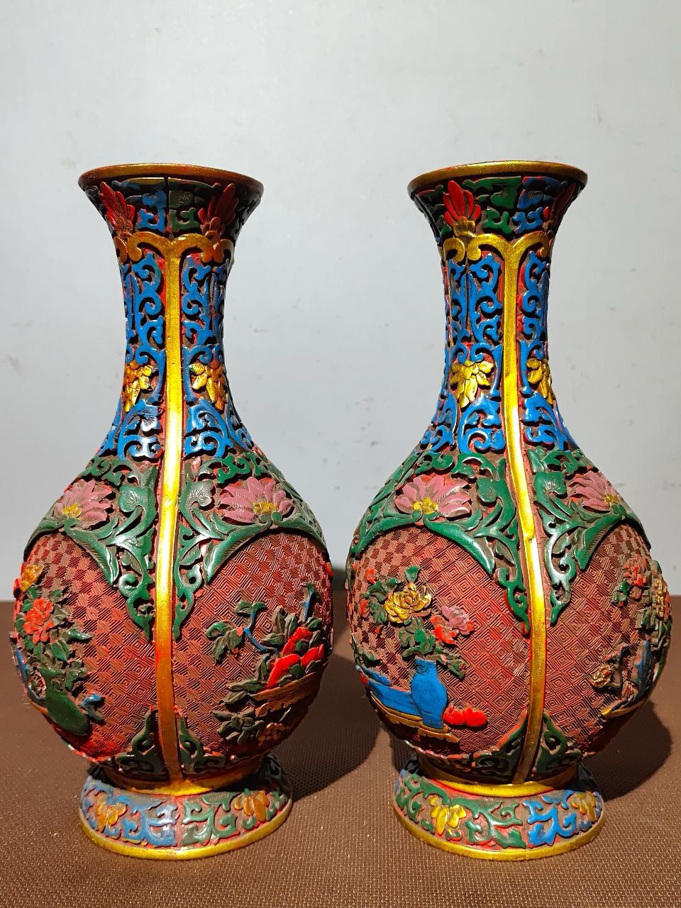 A pair of red lacquerware bottles
