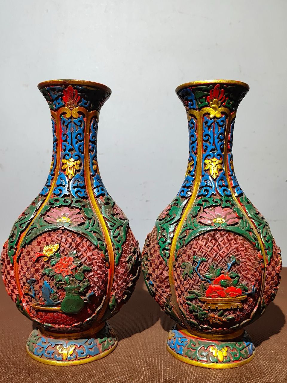 A pair of red lacquerware bottles