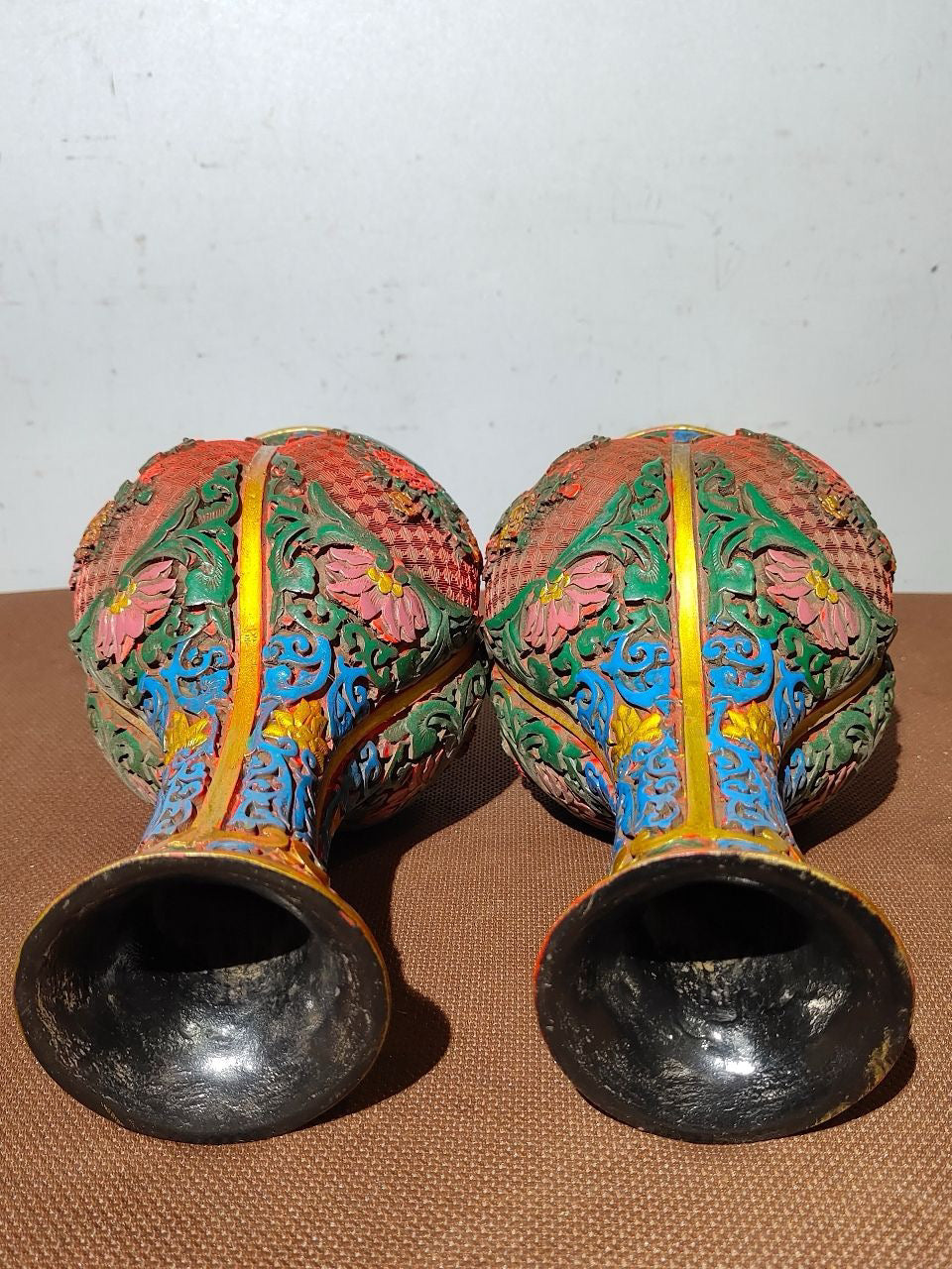 A pair of red lacquerware bottles