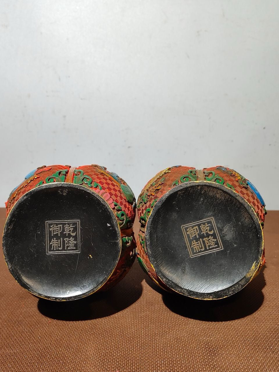 A pair of red lacquerware bottles