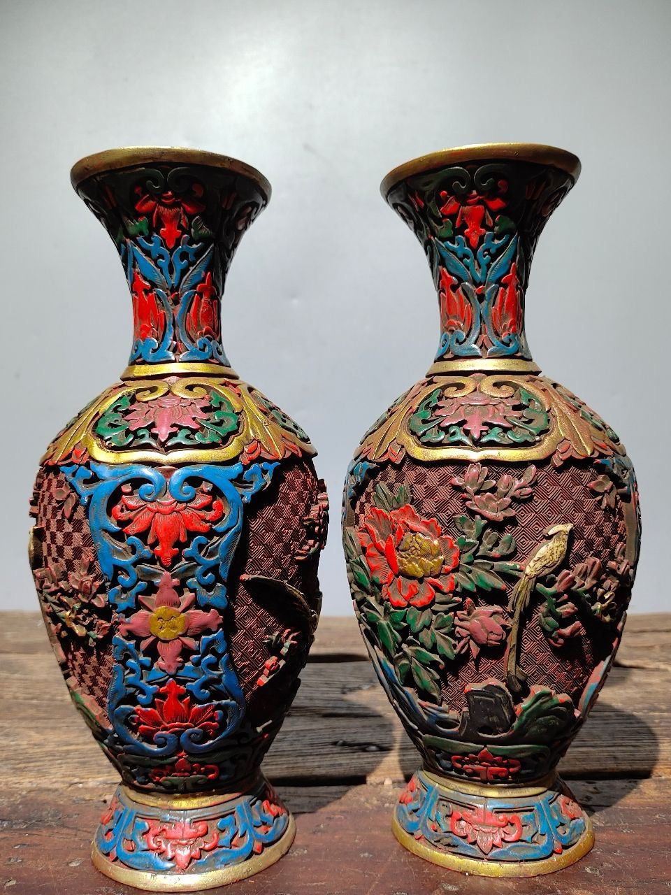 A pair of red lacquerware bottles