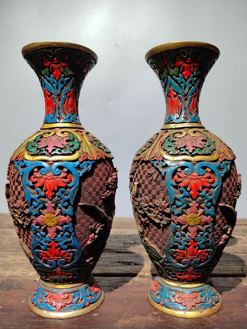 A pair of red lacquerware bottles