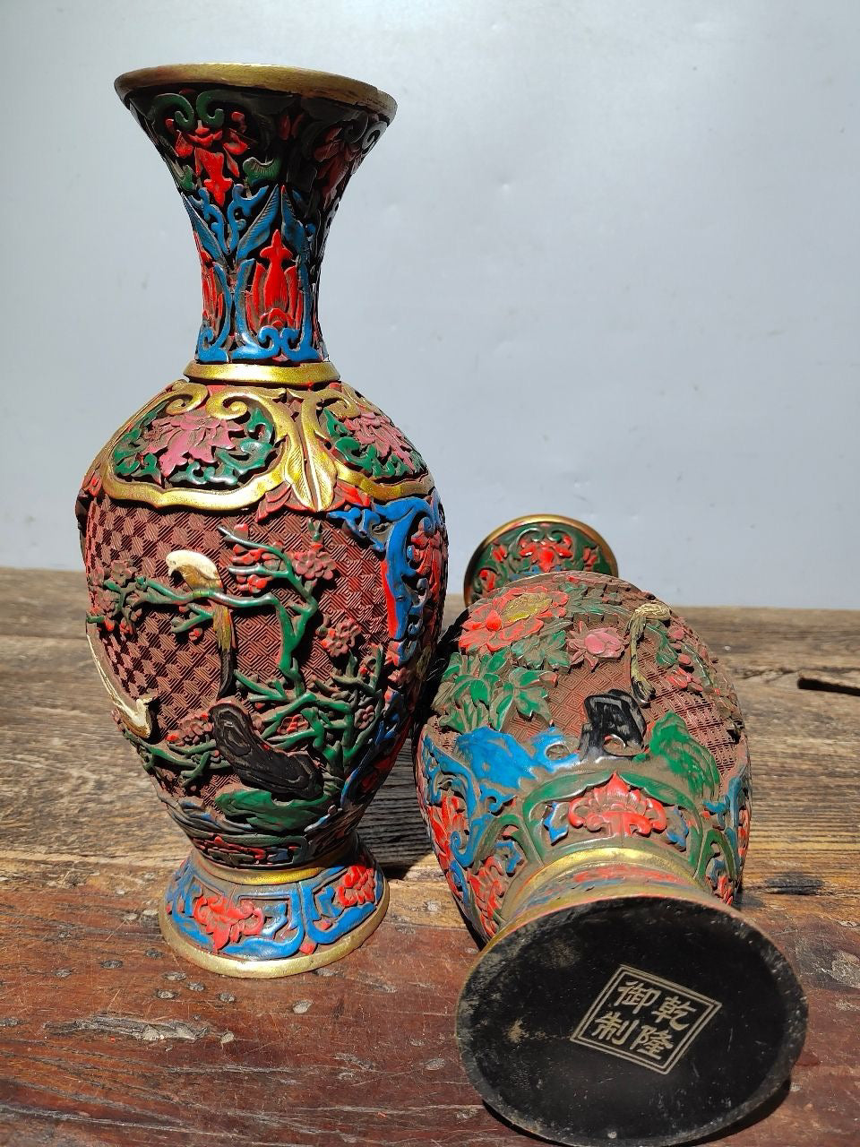 A pair of red lacquerware bottles
