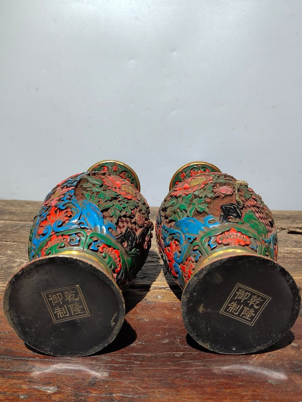 A pair of red lacquerware bottles