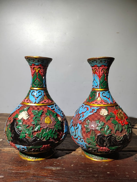 A pair of red lacquerware bottles
