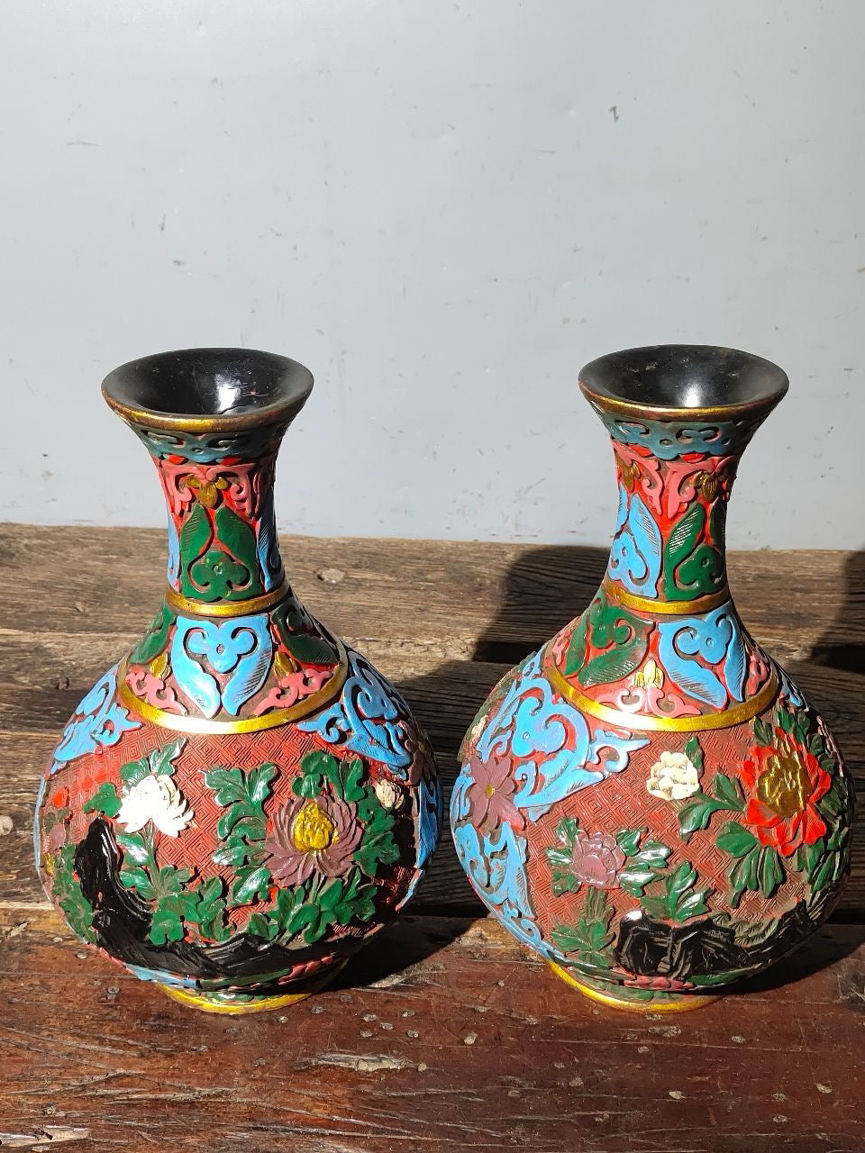 A pair of red lacquerware bottles