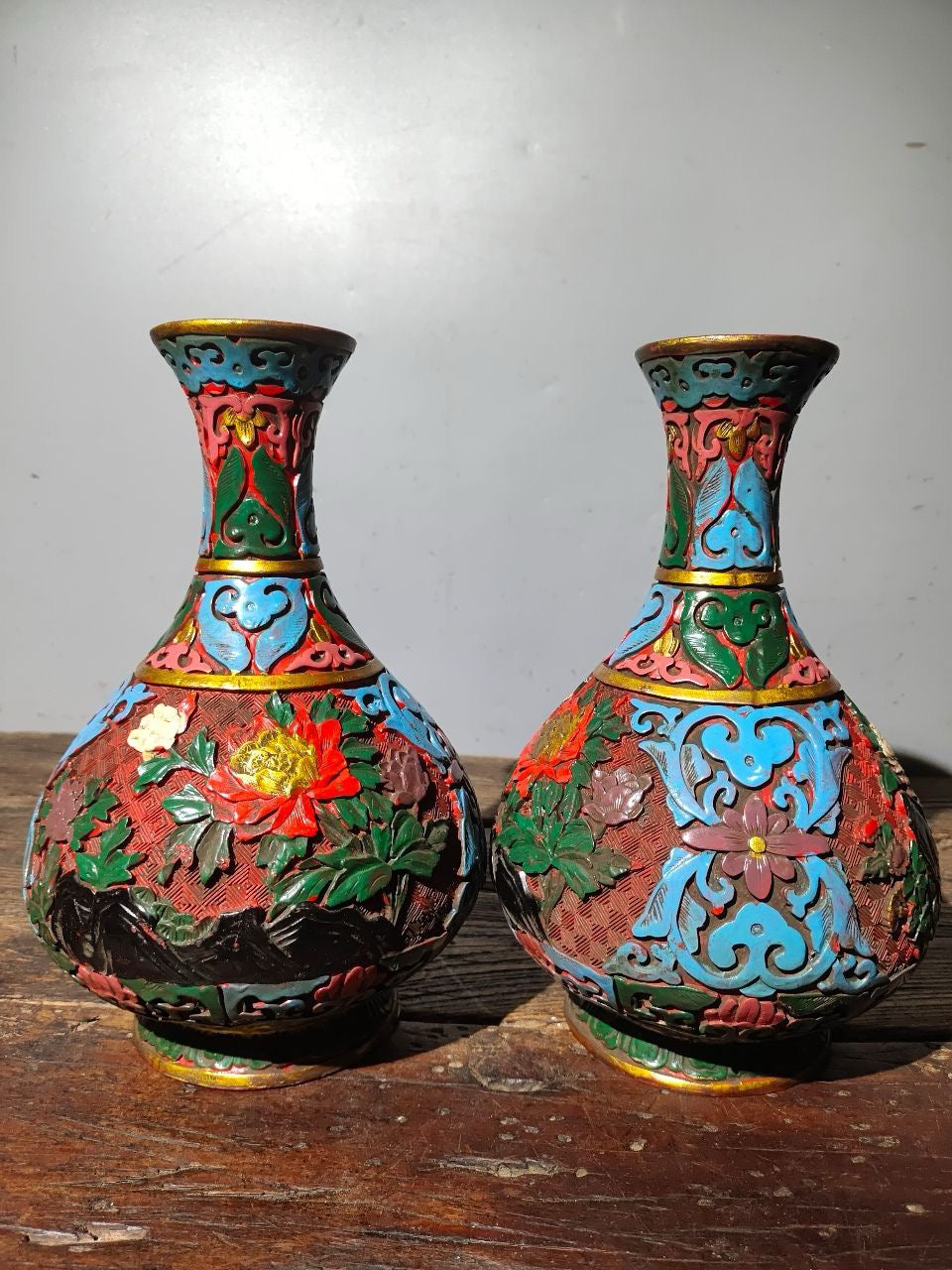 A pair of red lacquerware bottles
