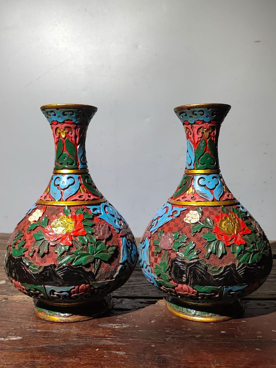 A pair of red lacquerware bottles