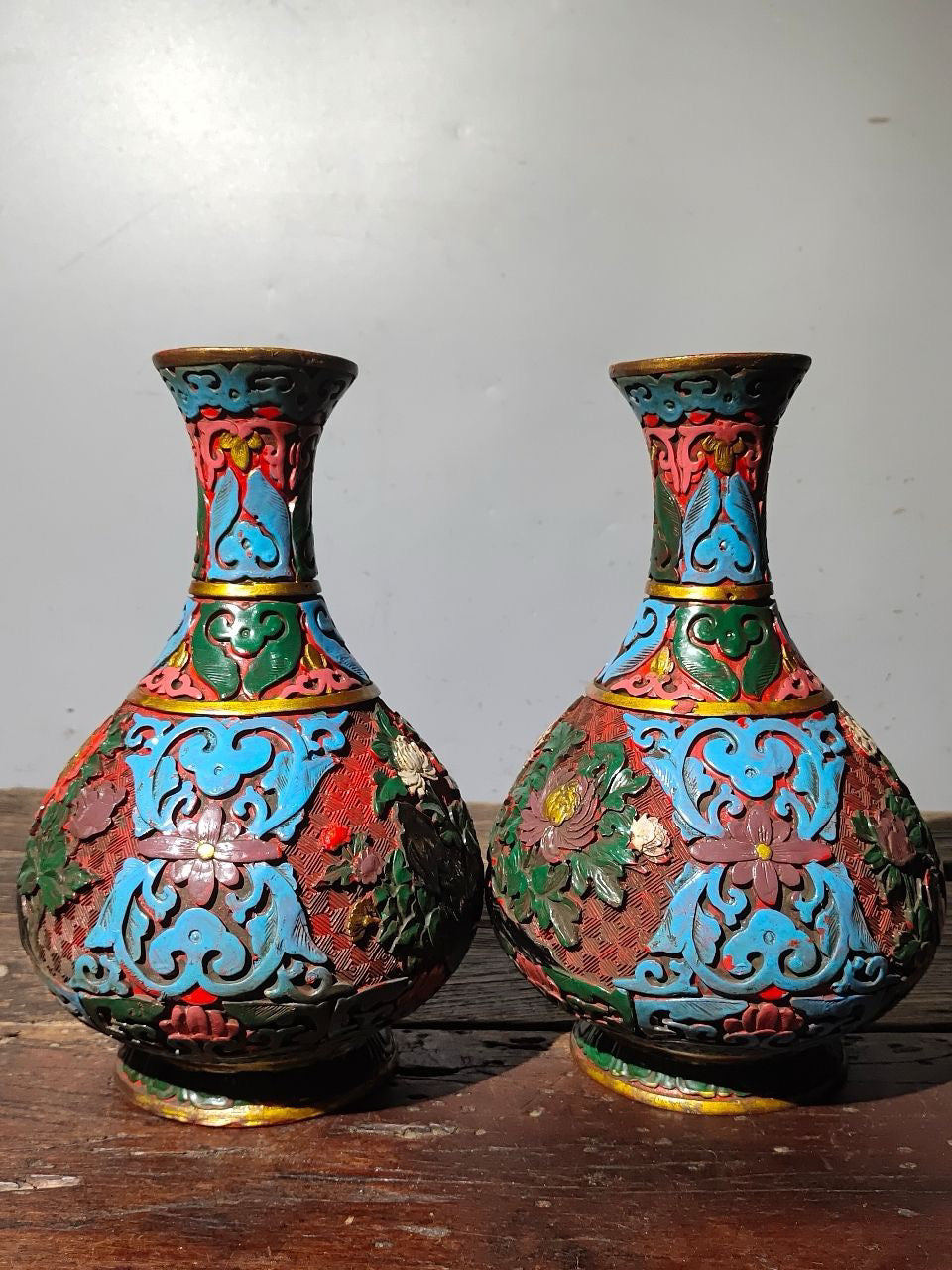 A pair of red lacquerware bottles