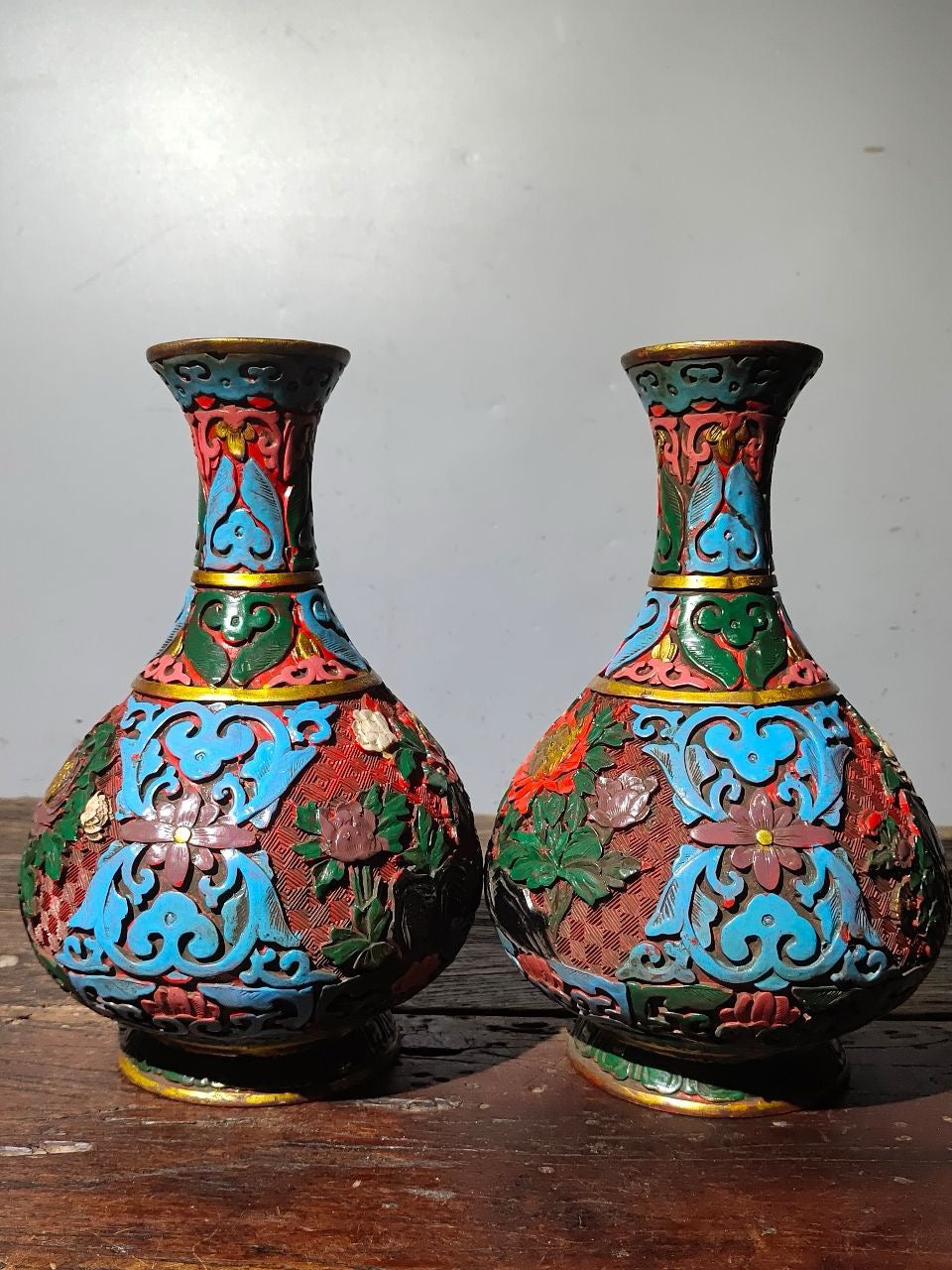 A pair of red lacquerware bottles