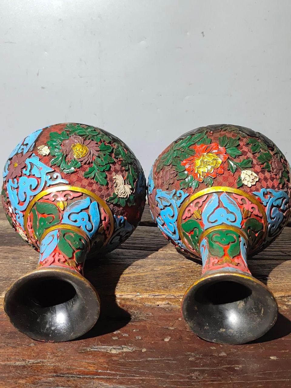 A pair of red lacquerware bottles
