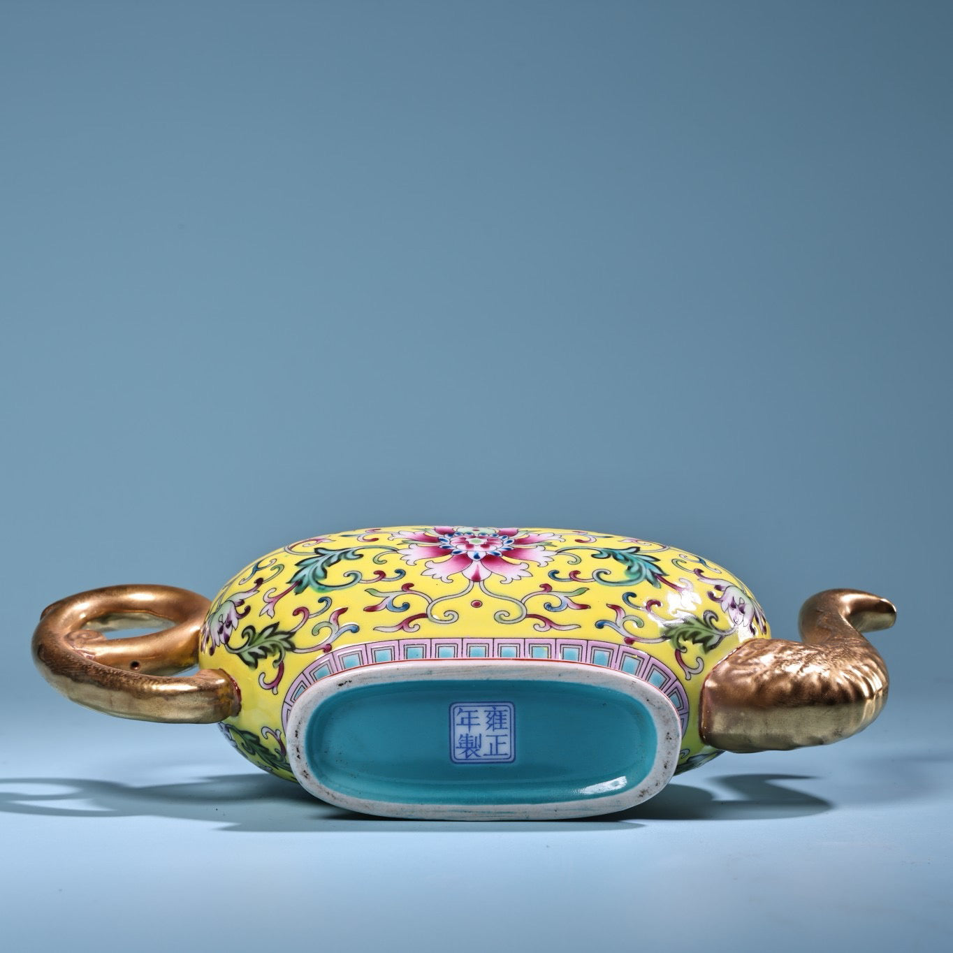 Hand painted enamel gilded gold colored porcelain teapot