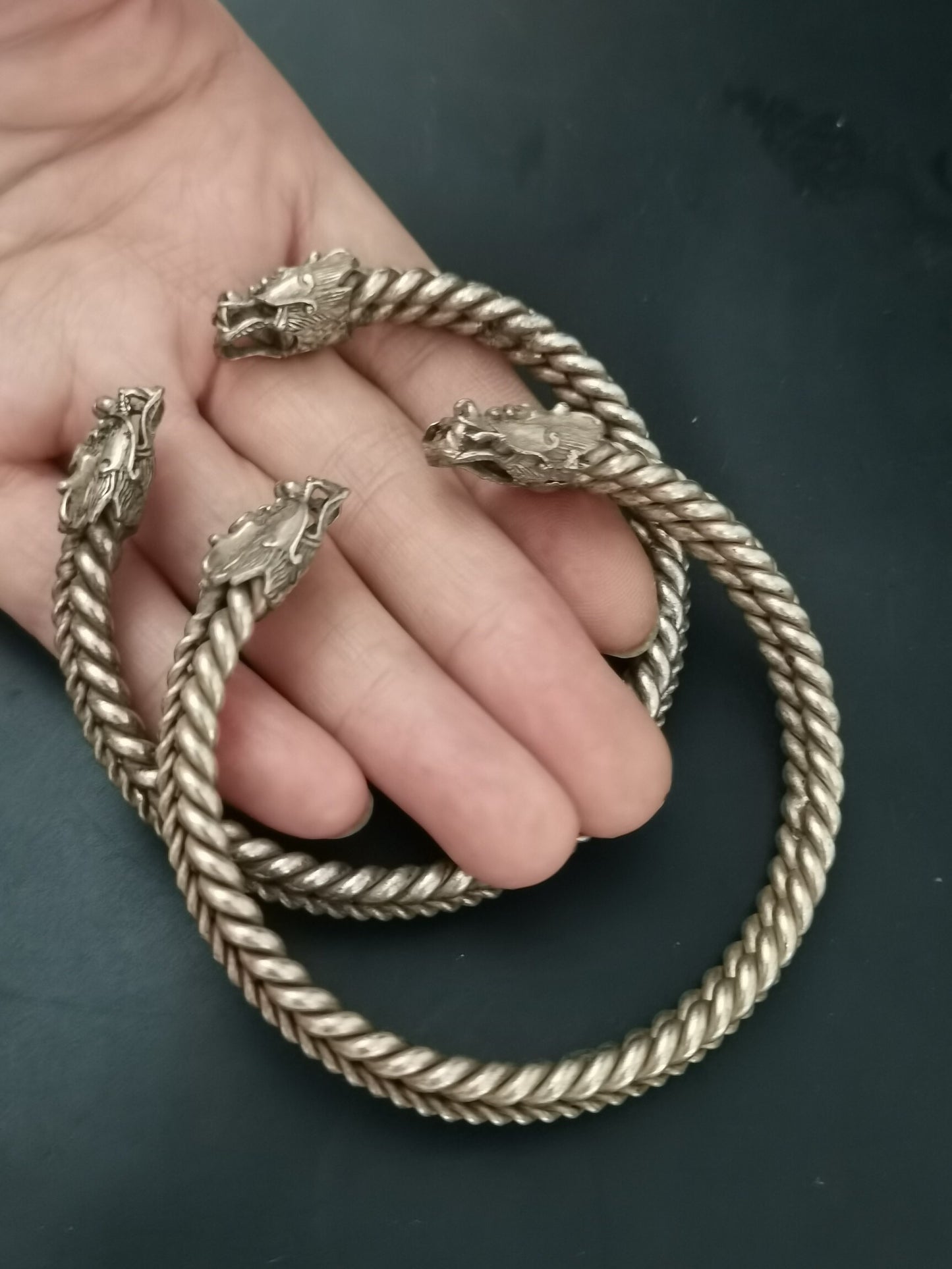 A pair of Chinese antique silver dragon head bracelets