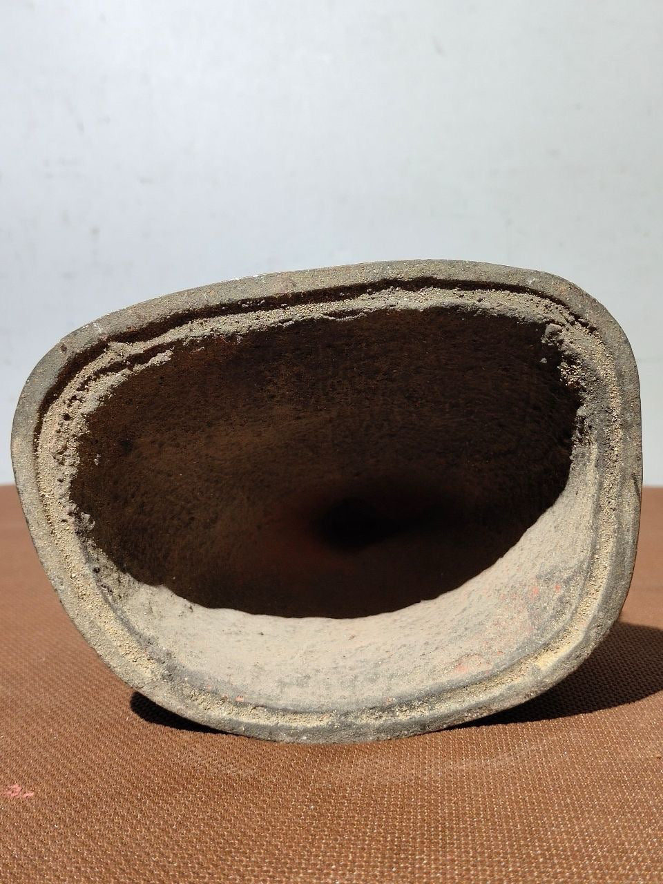 A statue of Maitreya Buddha with a large belly, made of copper, mud, gold, blooming, and sprinkled with cinnabar