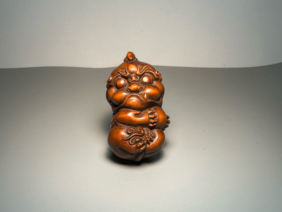 Chinese antique boxwood carving with exquisite craftsmanship, featuring a unicorn Pixiu holding a ball