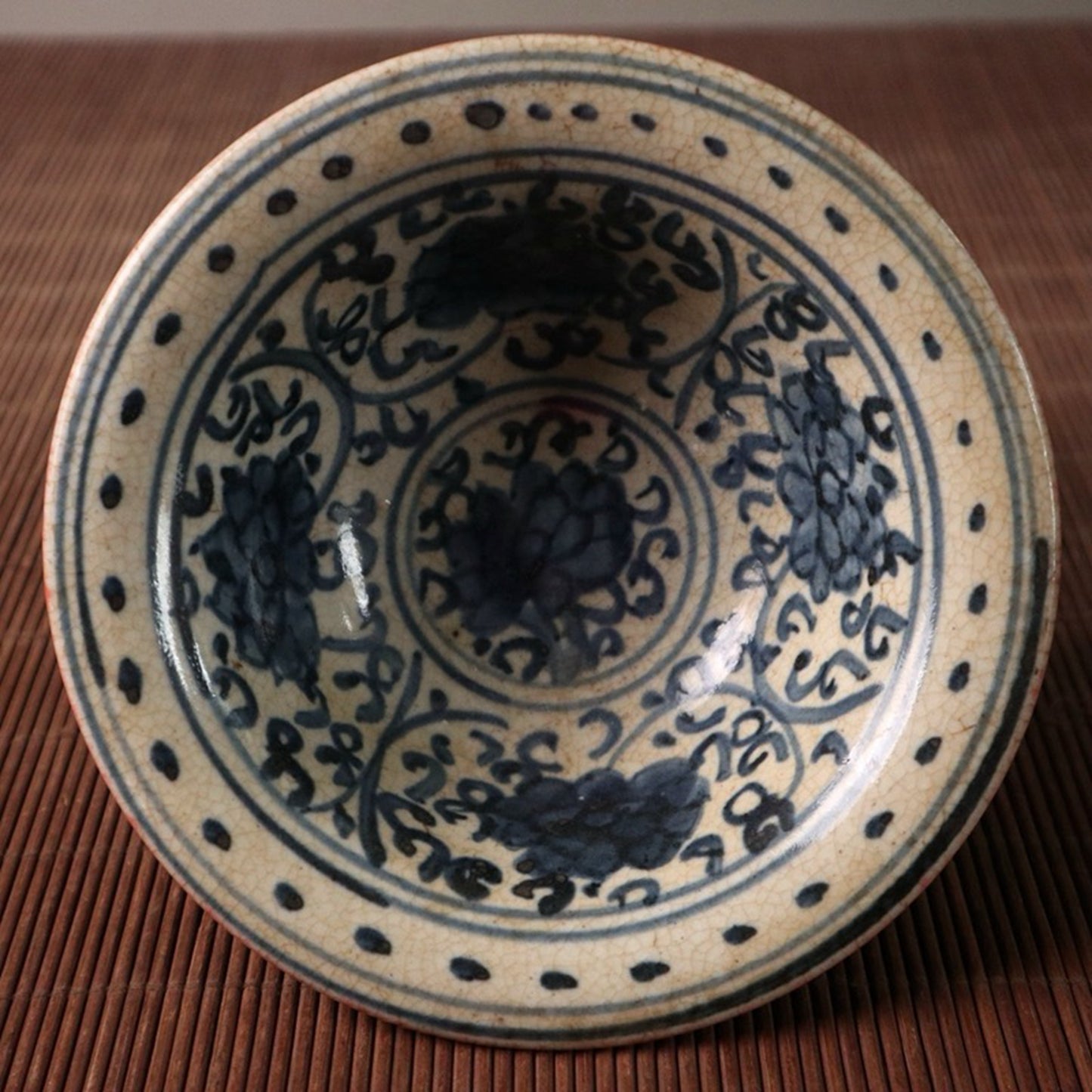 Small bowl with blue, white, and red glazed branches and lotus patterns