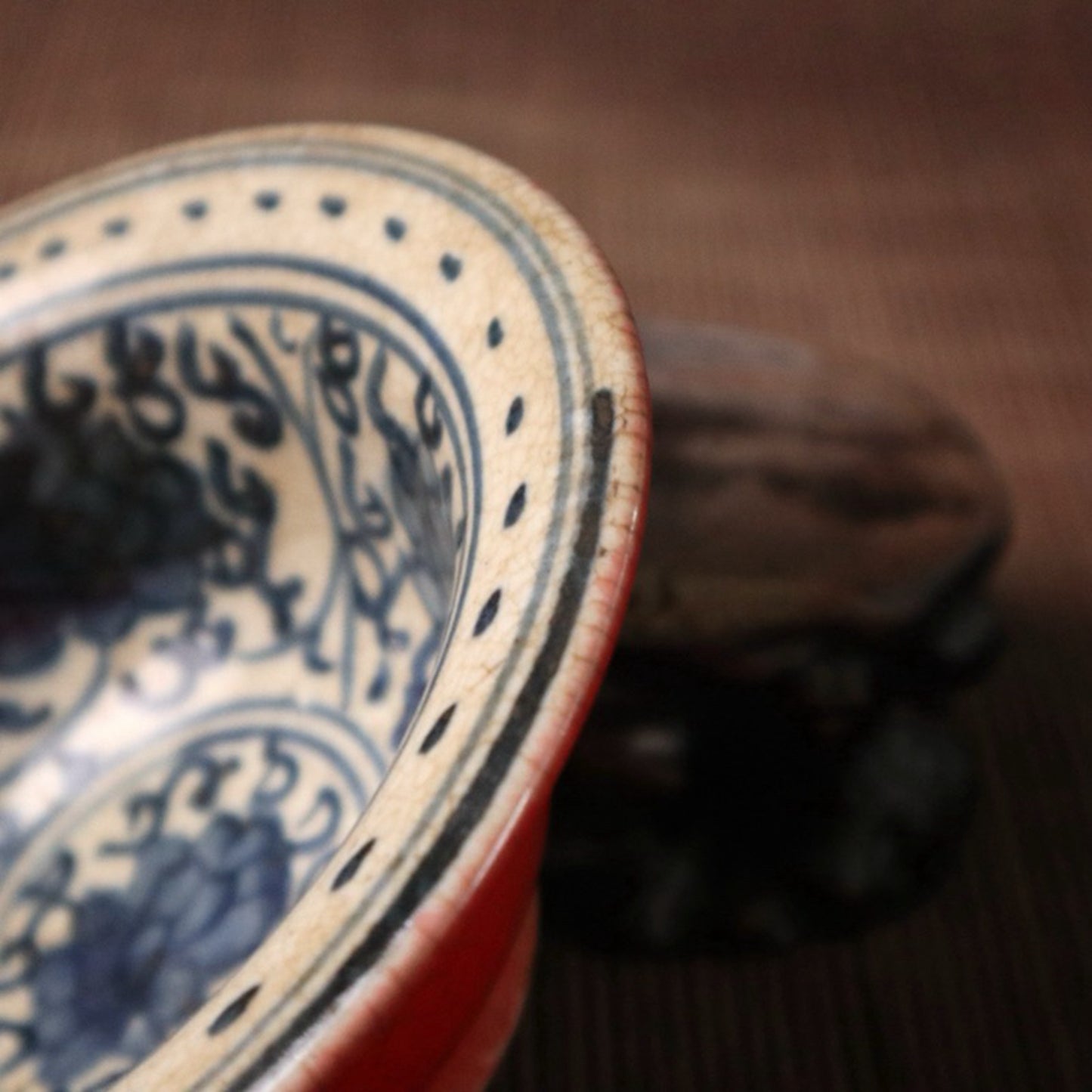 Small bowl with blue, white, and red glazed branches and lotus patterns