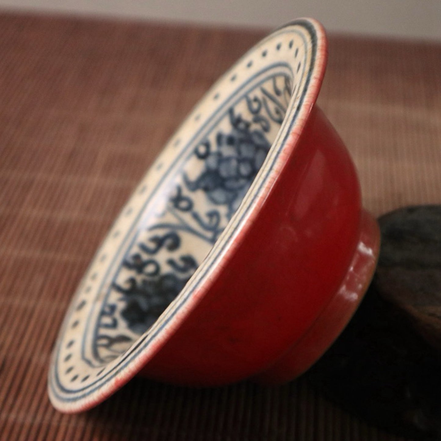 Small bowl with blue, white, and red glazed branches and lotus patterns