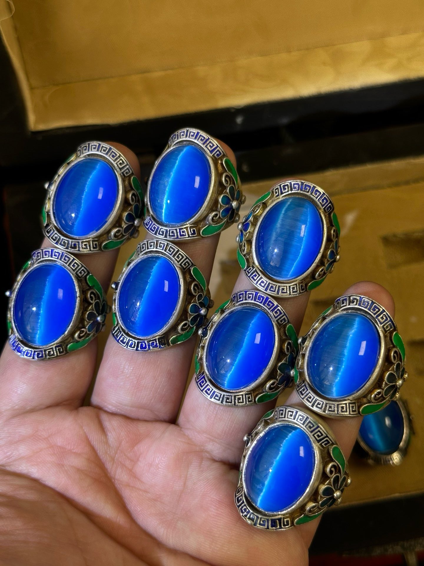 A box of Chinese antique blue cat eye rings