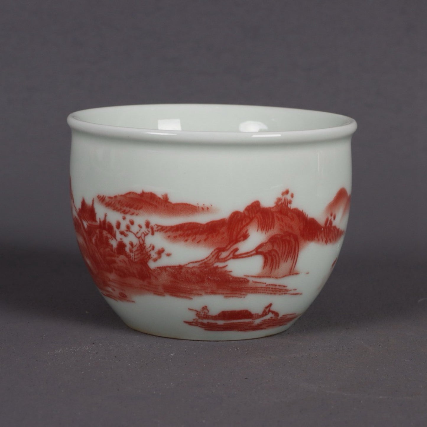 A pair of glazed red landscape patterned mouth cups