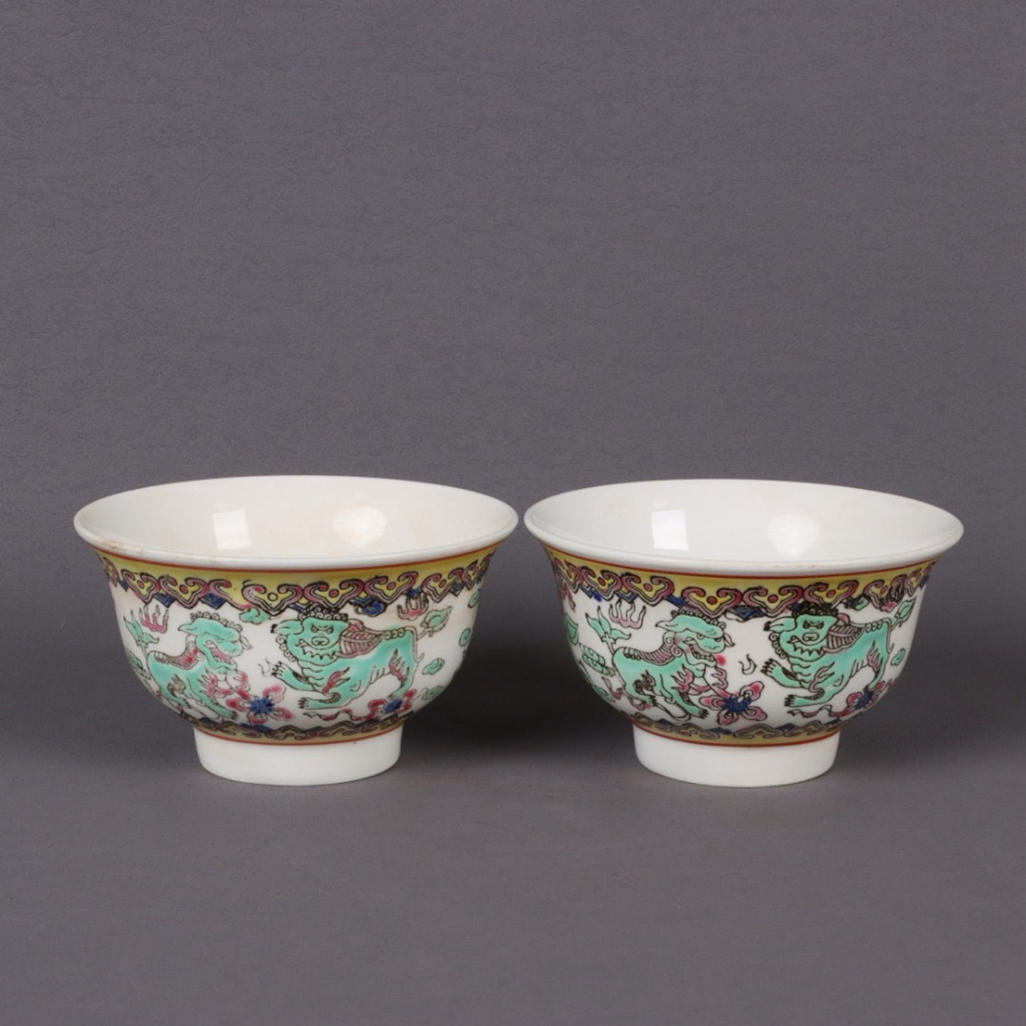 A pair of pink longevity patterned bowls