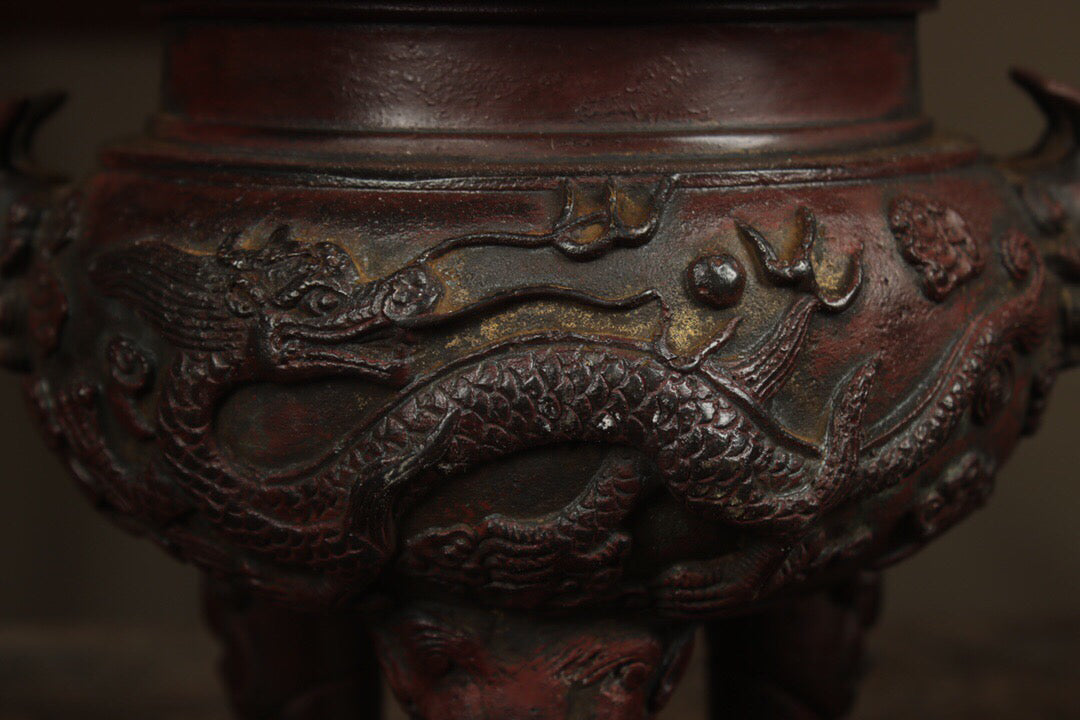 A Chinese antique pure copper incense burner with three legs and two dragons