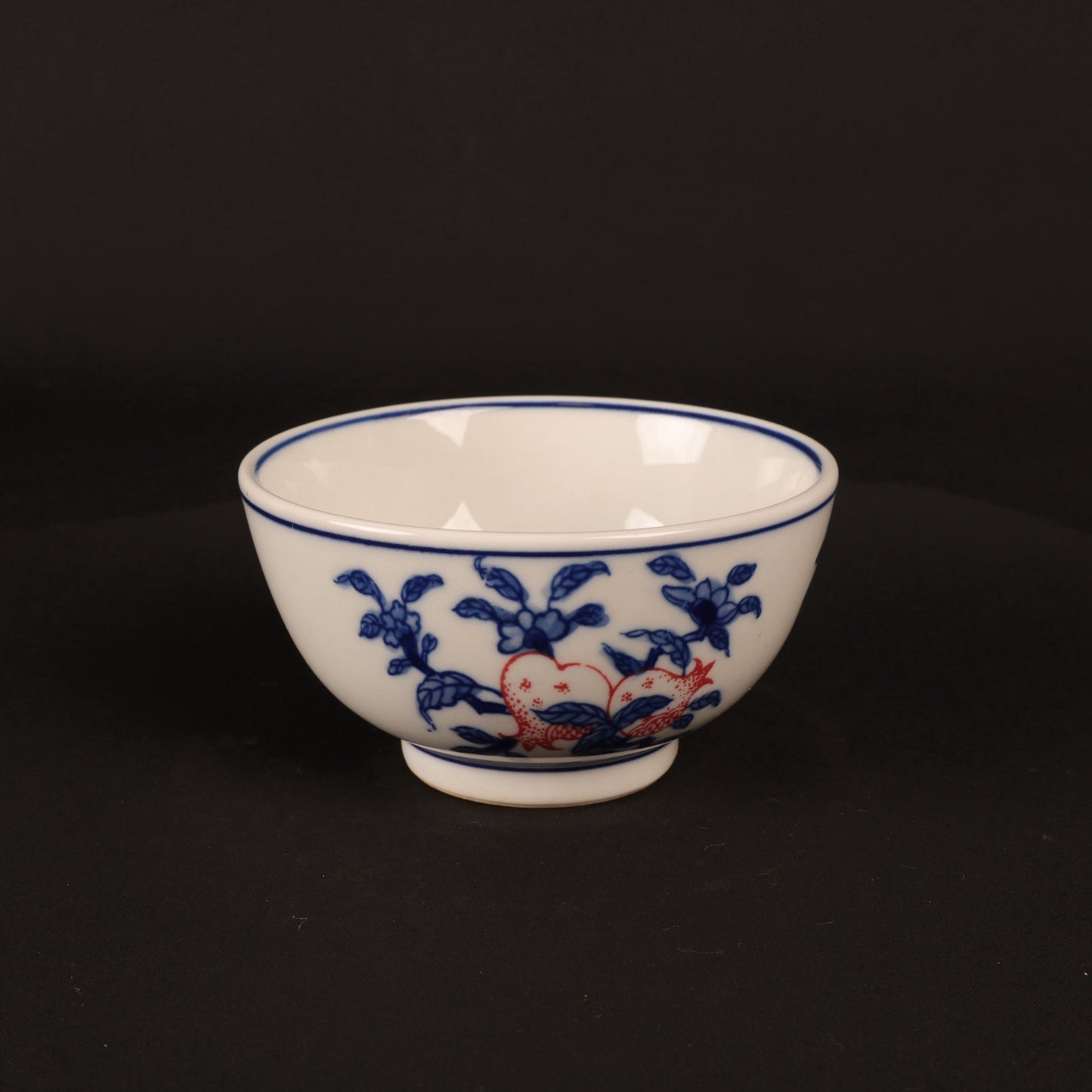 A pair of hand pressure cups with blue and white enamel, red blessings and longevity pictures