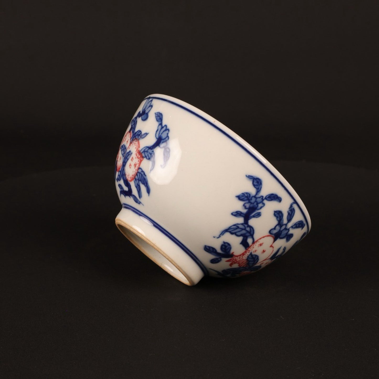 A pair of hand pressure cups with blue and white enamel, red blessings and longevity pictures