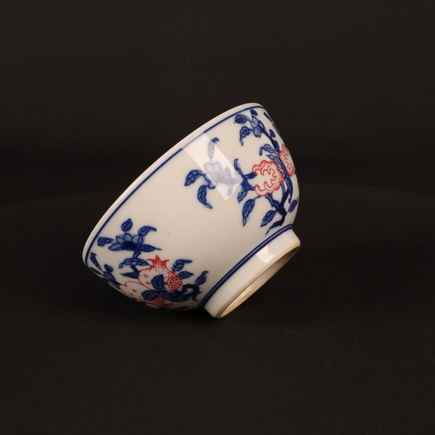 A pair of hand pressure cups with blue and white enamel, red blessings and longevity pictures