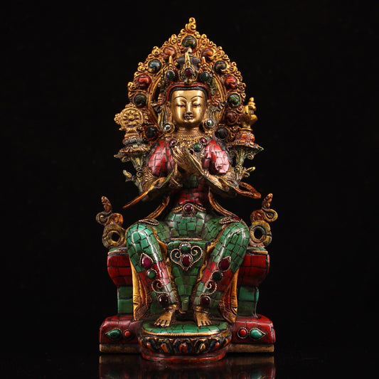 A pure copper handmade statue with inlaid gemstones, colorful paintings, and golden depictions, featuring a Buddha statue