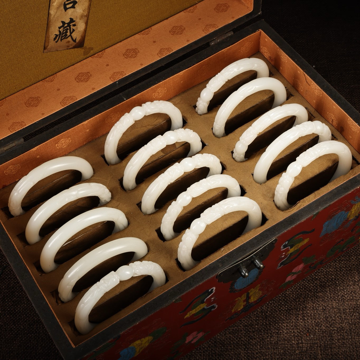 A box of Chinese antique dragon head white jade bracelets