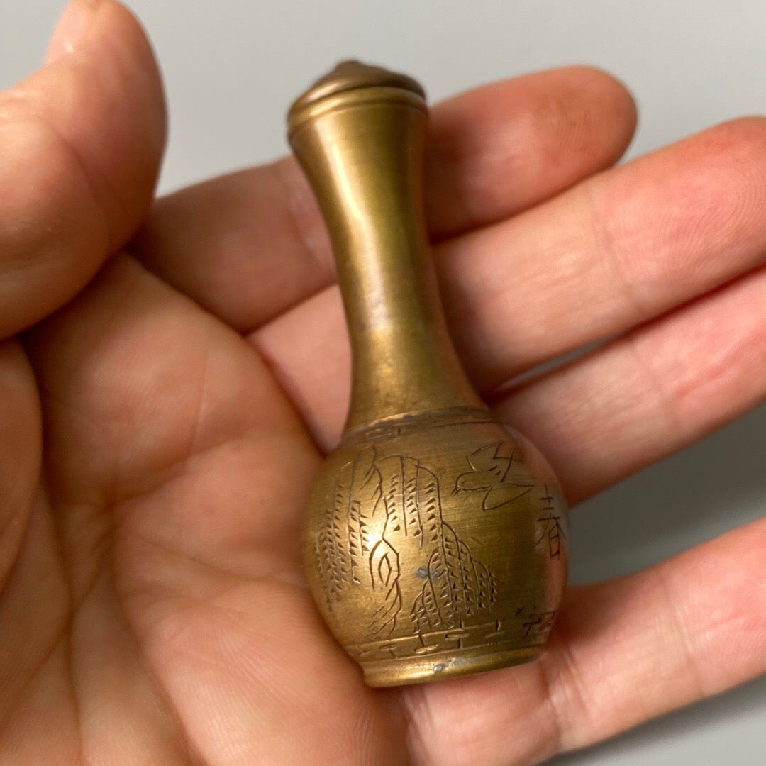 A set of carved Chinese antique brass snuff bottles from spring, summer, autumn, and winter