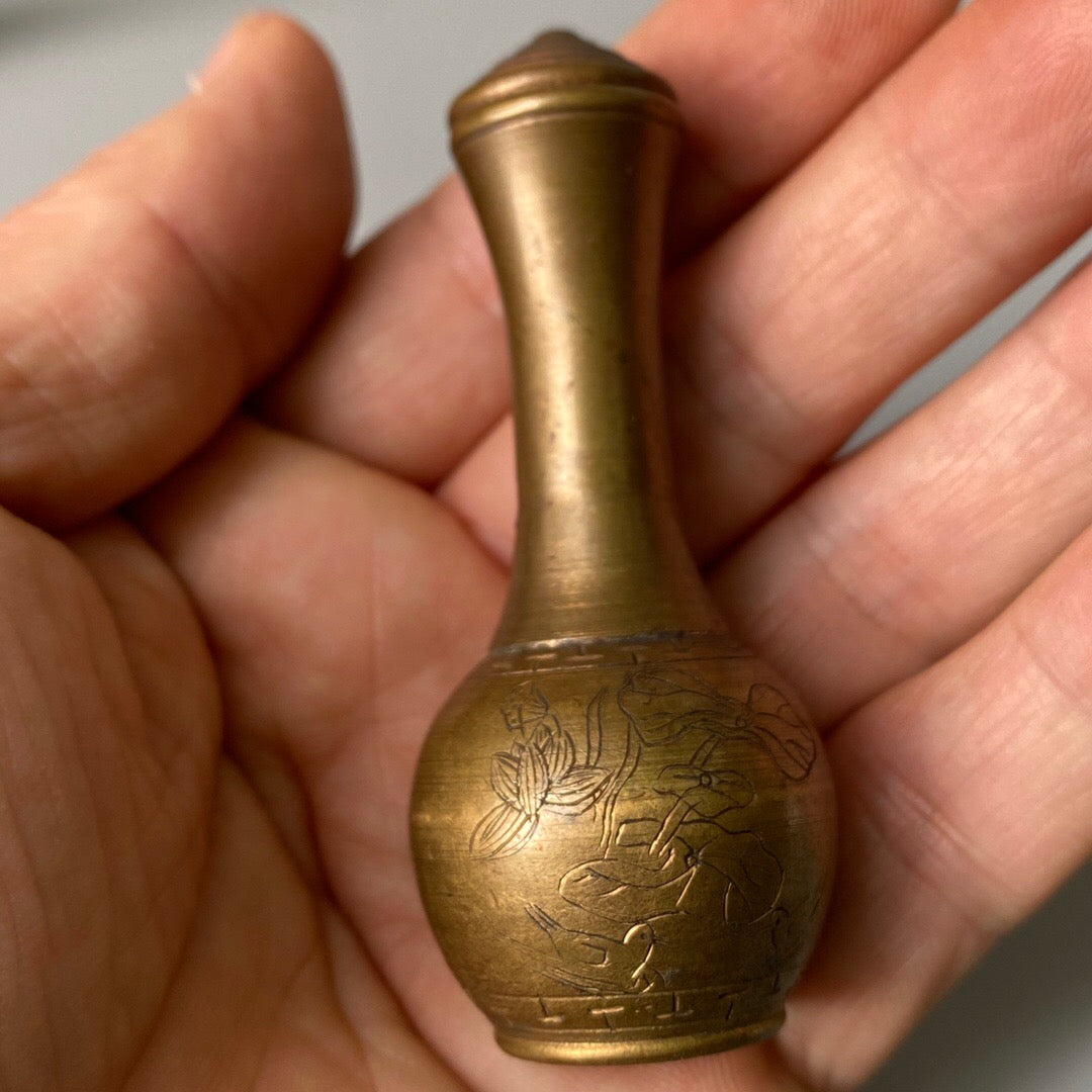 A set of carved Chinese antique brass snuff bottles from spring, summer, autumn, and winter