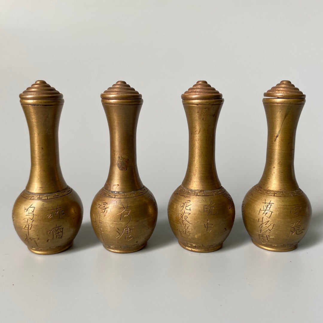 A set of carved Chinese antique brass snuff bottles from spring, summer, autumn, and winter