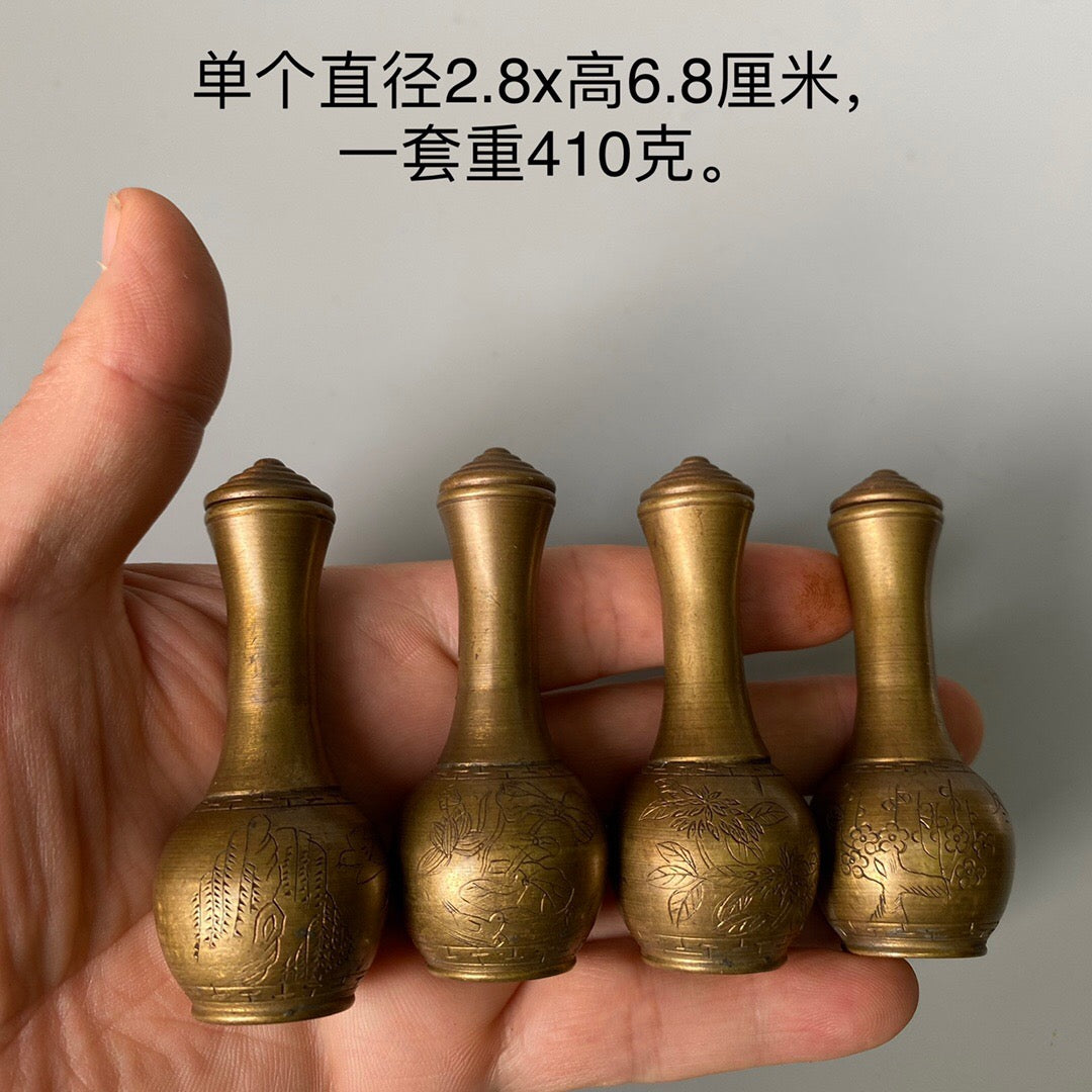 A set of carved Chinese antique brass snuff bottles from spring, summer, autumn, and winter