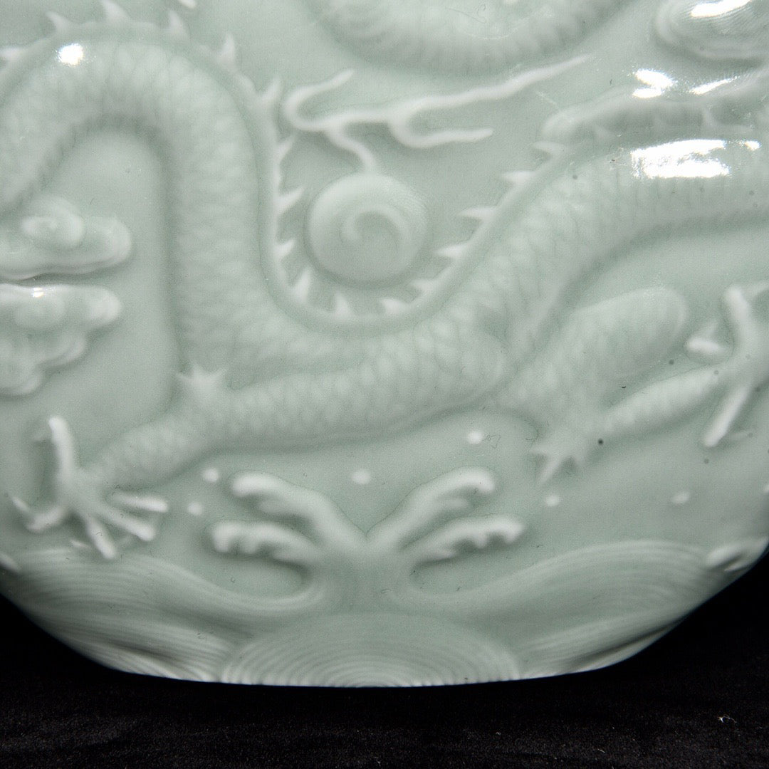 Single color glazed shallow carved dragon patterned moon hugging vase