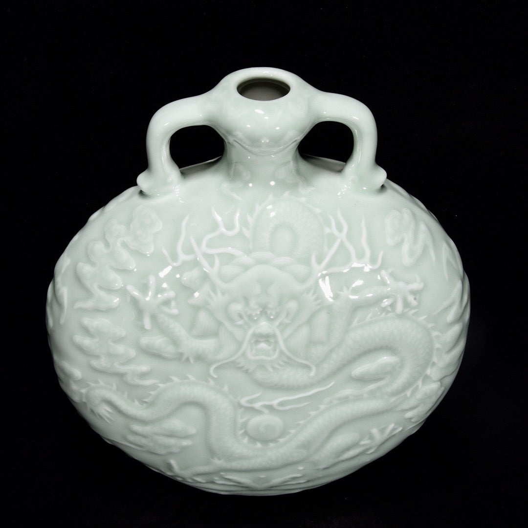 Single color glazed shallow carved dragon patterned moon hugging vase