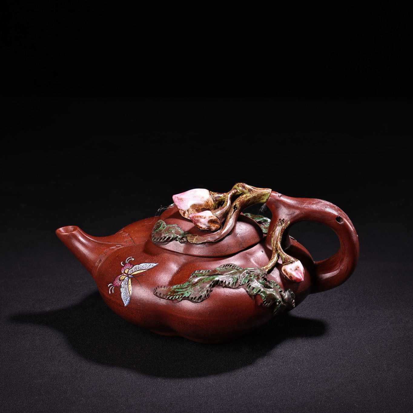 A red clay painted purple clay teapot